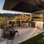 Backyard design with cantilevered shade structure and multiple seating areas.