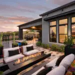 Custom backyard design with deco-tile decking, cantilevered fire table and multiple seating areas.