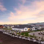 Custom community entrance with organized planting, real grass and roundabout driveway.