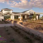 Custom community amenities with clubhouse, brick paver walkway and organized planting.