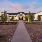 Custom community amenities with clubhouse, organized planting and uplighting.