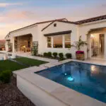 Custom backyard design with natural stone spa, metal trellis and cantilevered shade structure.
