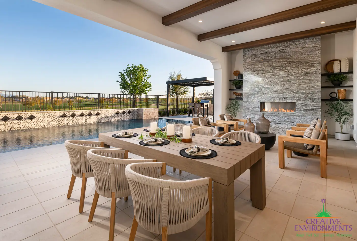 Custom backyard design with Spanish design style, floor-to-ceiling fireplace and multiple seating areas.