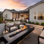 Custom backyard design with cantilevered fire table, large planters and large metal cutouts.