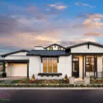 Custom front yard design with organized planting, artificial turf and tree lighting.