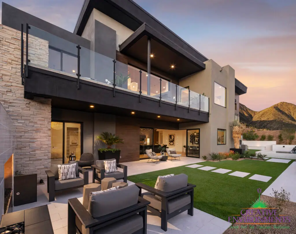 Custom backyard design with artificial turf and multiple seating areas