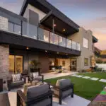 Custom backyard design with artificial turf and multiple seating areas