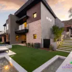 Custom backyard design with water features, cantilevered shade structure and fireplace.