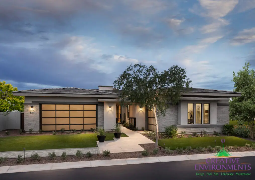 Custom front yard design with tree lighting, artificial turf and natural stone tile walkway.