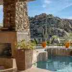 Backyard design with multiple seating areas and fireplace.