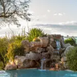 Backyard design with natural rock water fall.