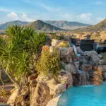 Backyard design with natural stone waterfall into pool