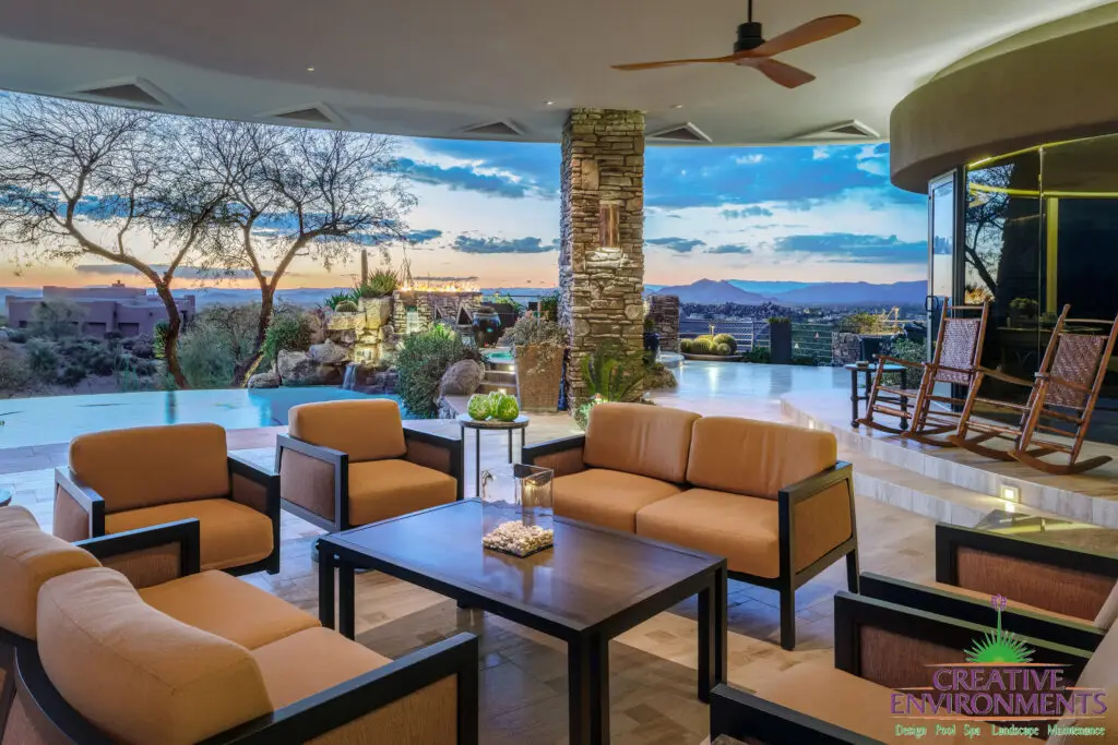 Backyard design with multiple seating areas and outdoor fan.