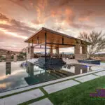 Custom backyard design with baja step in pool and angled shade structure next to pool.