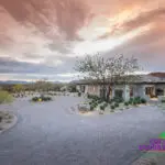 Custom roundabout driveway with pavers and desert plants.