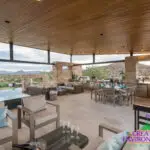 Custom angled shade structure with recessed lighting, multiple seating areas and raised spa.