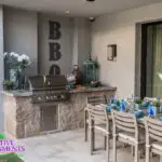 Custom outdoor patio with outdoor BBQ, dining area and indoor/outdoor fusion.