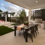 Custom backyard design with custom metal cutouts and outdoor kitchen.