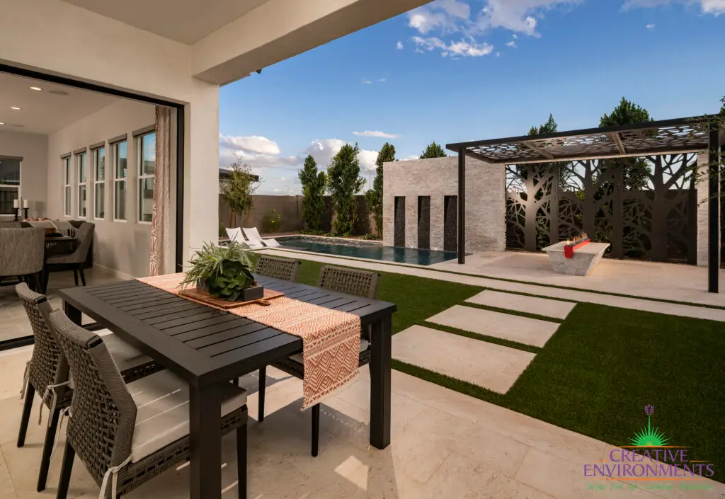 Custom backyard design with custom metal shade structure and privacy hedges.