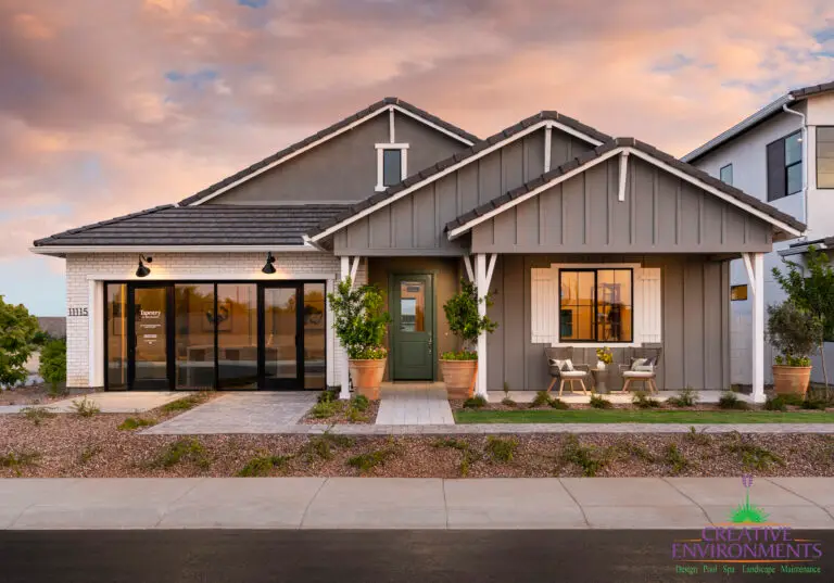 Custom front yard design with potted plants and real grass.