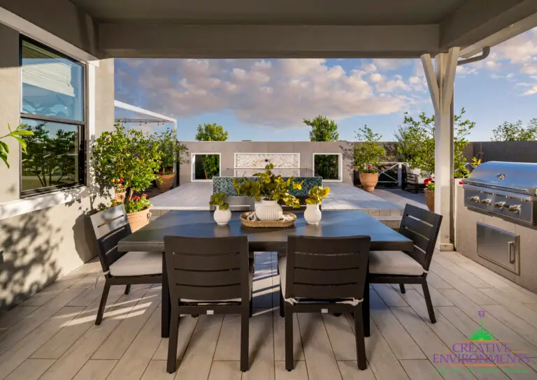 Custom backyard design with outdoor kitchen and dining area.