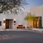 Custom community area with fireplace, multiple seating areas and a roundabout driveway.
