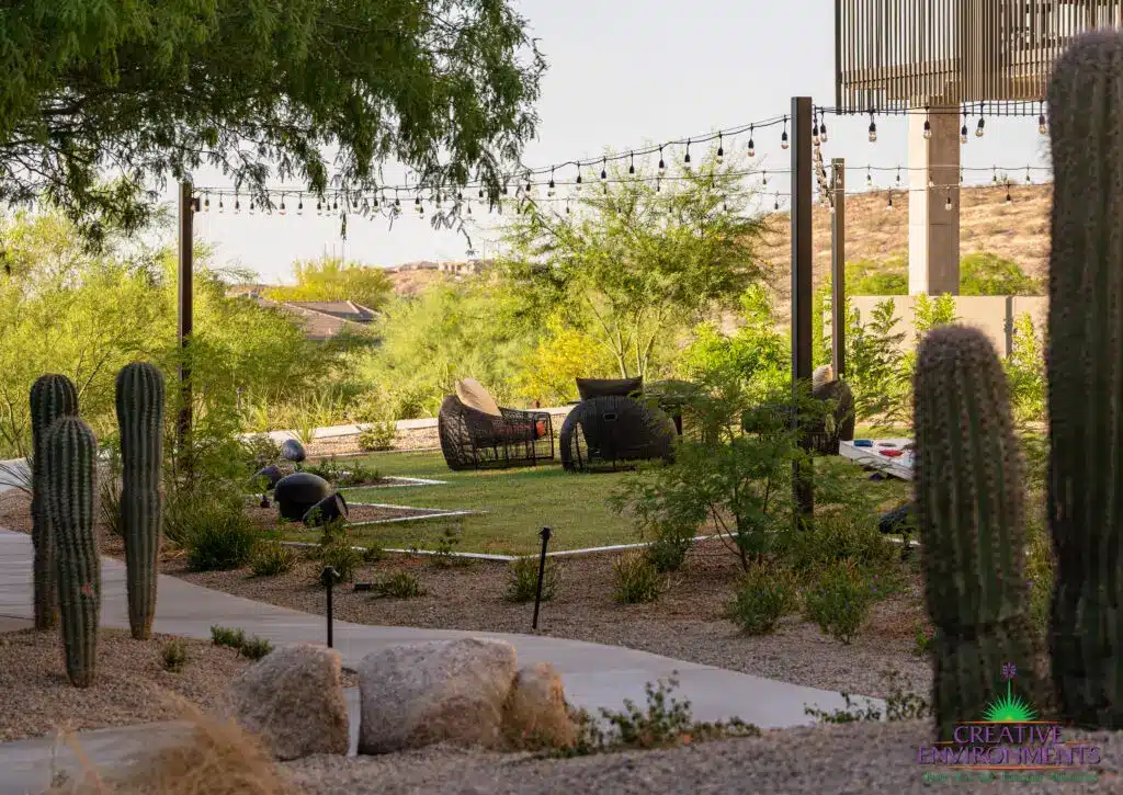 Custom community area with string lights, pathway and real grass.