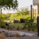 Custom community area with string lights, pathway and real grass.