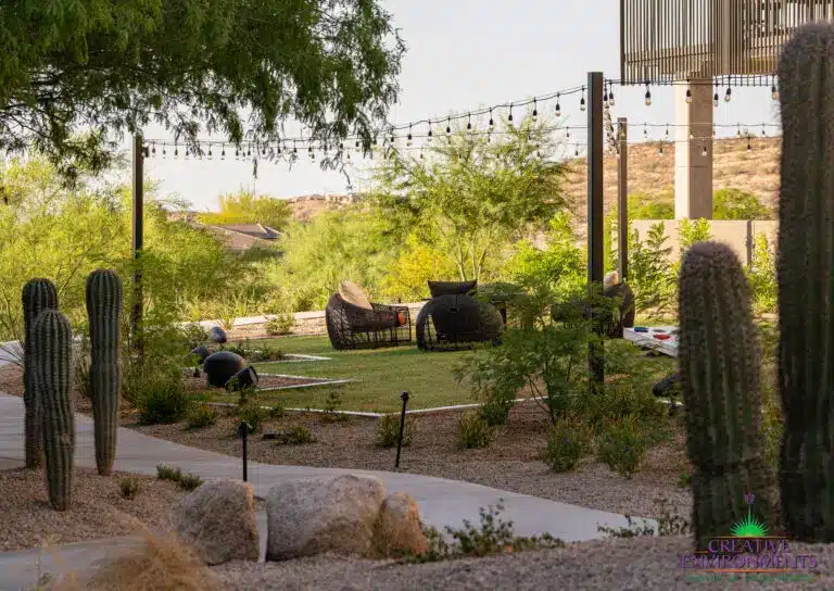 Custom community area with string lights, pathway and real grass.