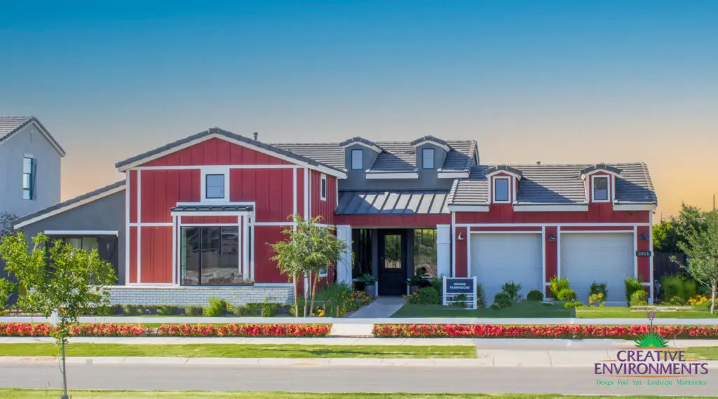 Custom front yard design with organized planting, annuals and farmhouse design.
