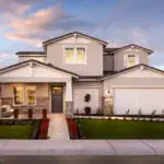 Custom front yard design with organized planting, tree lighting and artificial turf.