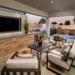 Custom backyard design with outdoor tv, water feature into pool and outdoor BBQ.