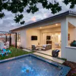 Backyard design with string lights and multiple seating areas