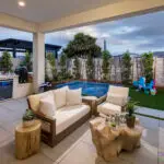 Backyard design with kid's pool and outdoor kitchen.