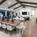 Custom indoor/outdoor living experience with deco-tiled water and fire feature into pool.