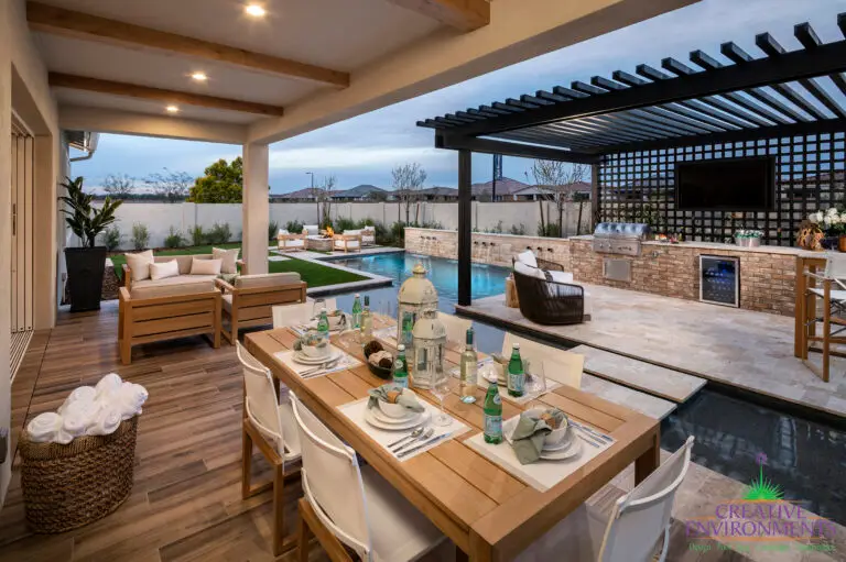 Backyard design with slatted metal shade structure, outdoor kitchen and multiple seating areas