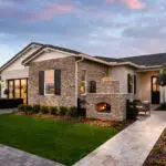 Front yard design with entryway fireplace and pavers.