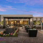 Custom entryway with water feature, large planters and up lighting.
