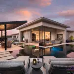 Custom backyard design with angled shade structure, zero-edge pool and Jesus steps.