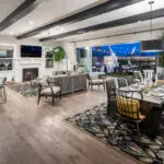 Custom indoor/outdoor living experience with string lights and multiple seating areas.