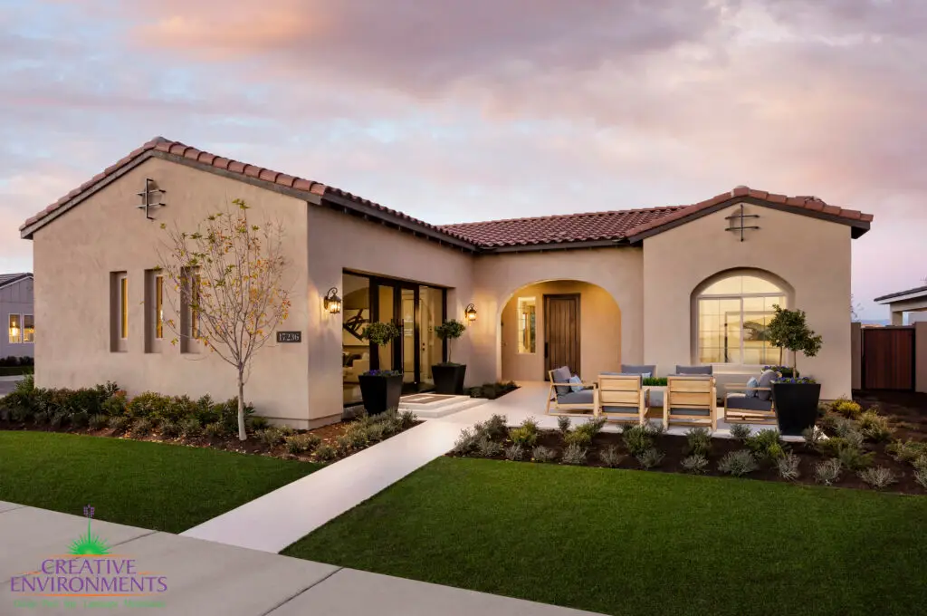 Custom front yard design with seating area, artificial turf and organized planting.