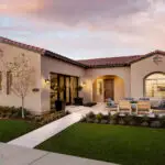 Custom front yard design with seating area, artificial turf and organized planting.