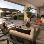 Custom backyard design with rain curtain water feature, multiple seating areas and large baja step in pool.