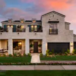 Custom front yard design with real grass, organized planting and up lighting.