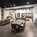 Custom indoor/outdoor fusion with outdoor shelving, multiple seating areas and floor-to-ceiling marble fireplace.