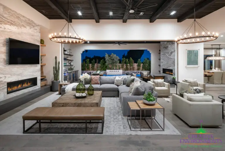 Custom indoor/outdoor design fusion with similar marble fireplaces, multiple seating areas and privacy hedges.