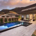 Custom travertine decking, cacti and metal trellis with ivy.