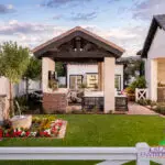 Custom backyard design with real grass, water fountain and shade structure.