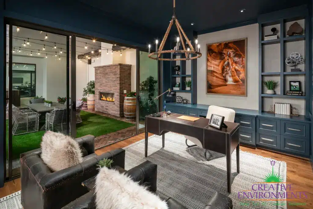Custom indoor/outdoor design fusion with string lights, brick fireplace and artificial turf.