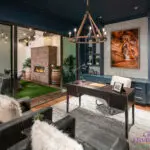 Custom indoor/outdoor design fusion with string lights, brick fireplace and artificial turf.